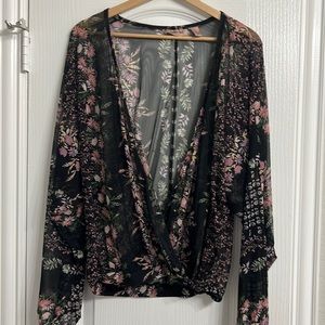 Long sleeve top with cinched waist. See through material. Size M